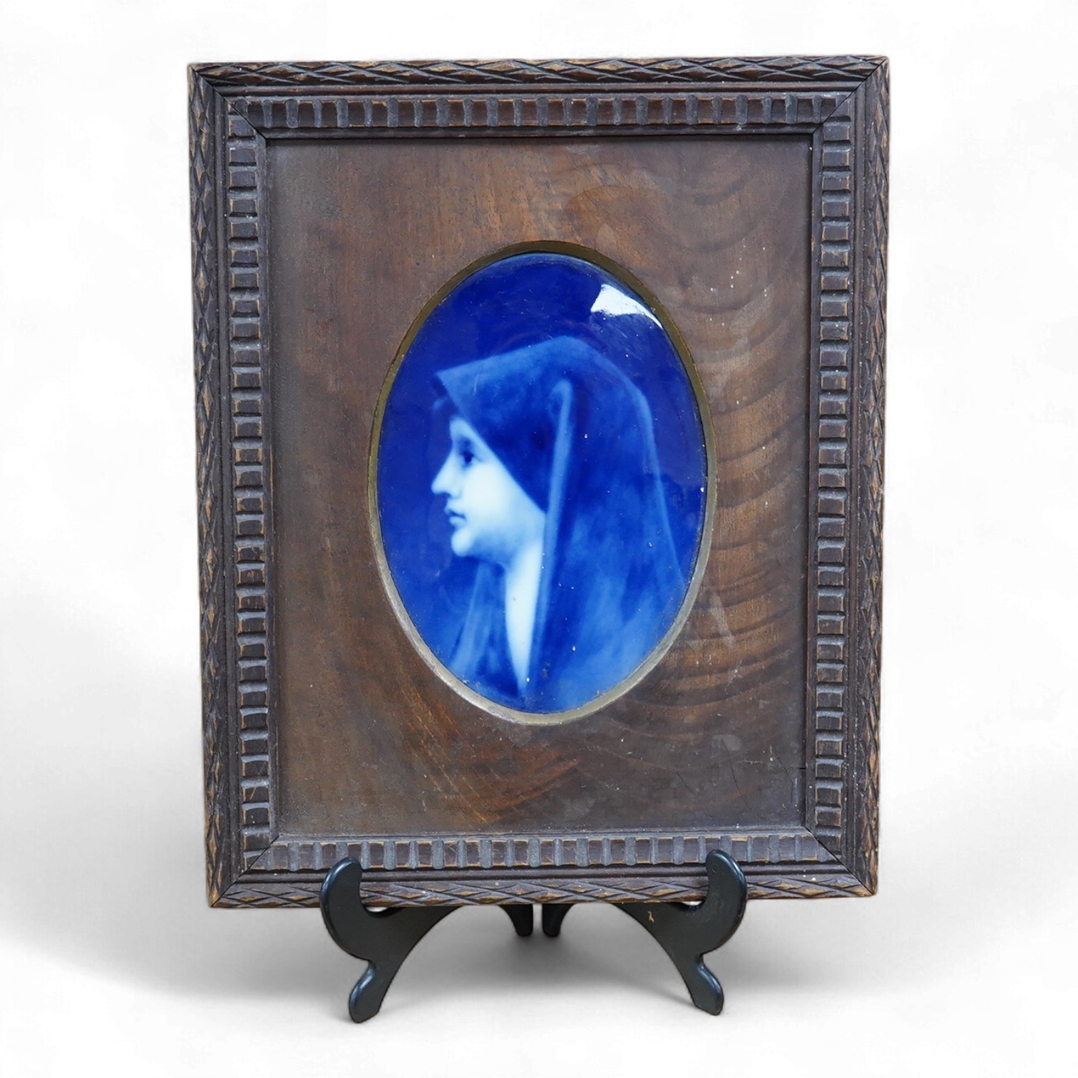 A Limoges plaque depicting a portrait of Saint Fabiola after Jean-Jacques Henner, framed, 29cm high